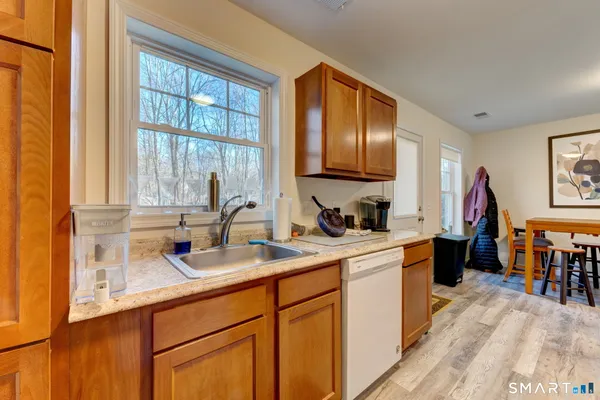 a kitchen with a sink a counter top space and cabinets