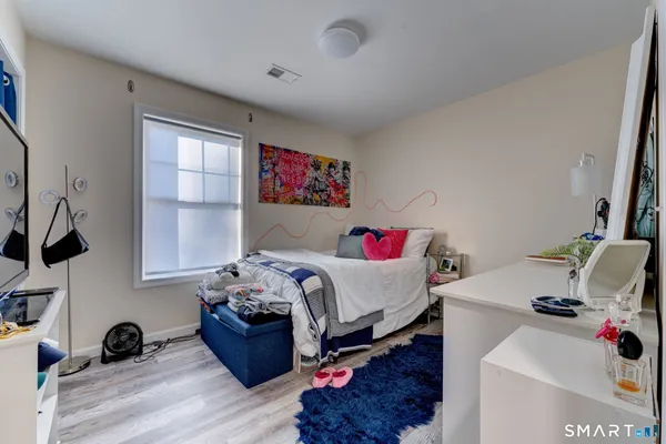 a bedroom with a bed and a couch