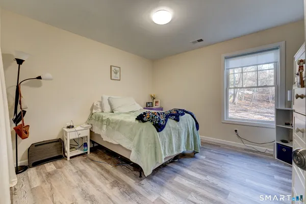 a bedroom with a bed and a window