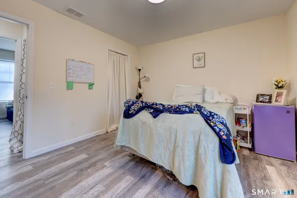 a bed room with a bed and a book shelf