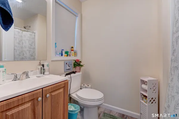 a bathroom with a sink a toilet and mirror