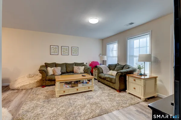 a living room with furniture and a lamp