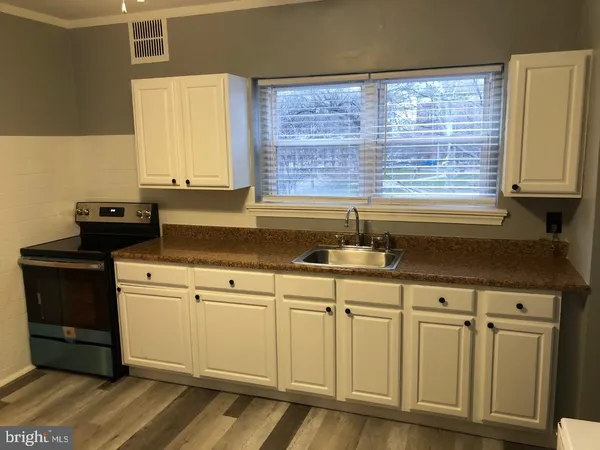 a kitchen with a sink and a stove