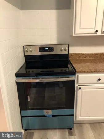 a view of kitchen and empty room