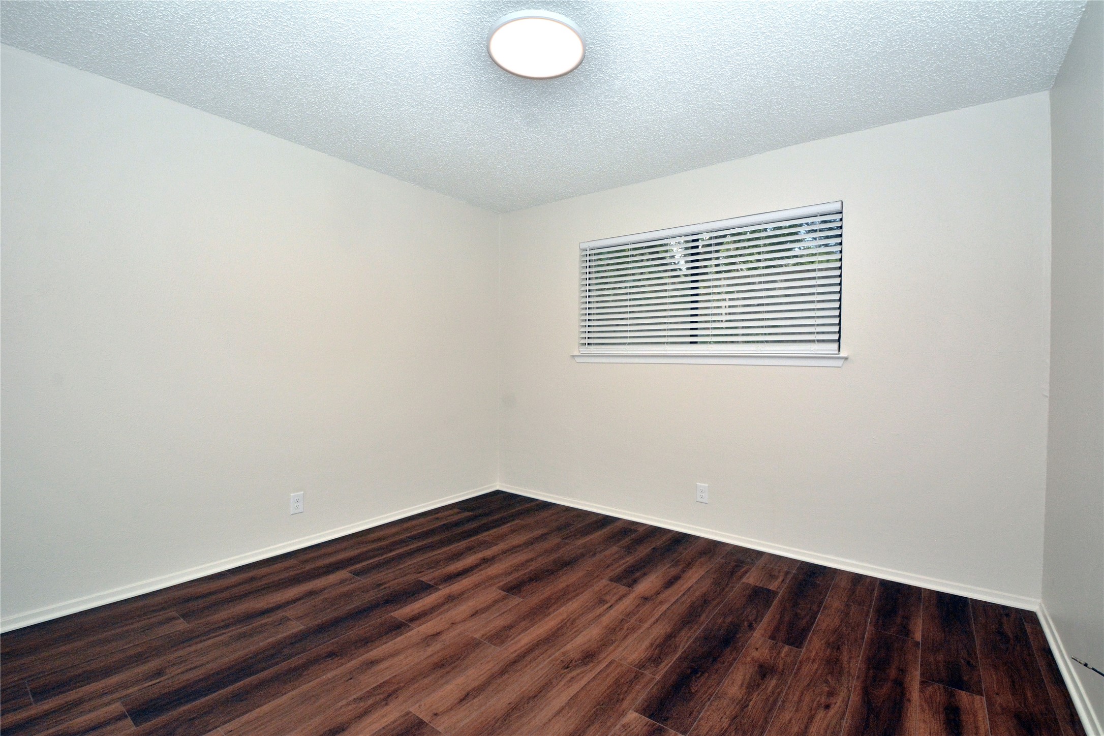 11314 Walnut Ridge Drive, Unit B Austin, TX 78753 - Photo 13 of 19 A quiet bedroom with rich wood flooring offers a serene personal retreat.