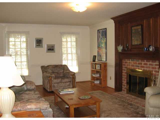 Living room - note the masonry fireplace, hardwood floors and smooth ceilings