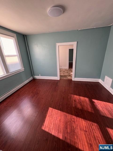 295 Midland Avenue, Unit 1 Garfield, NJ 07026 - Photo 3 of 8 wooden floor in an empty room with a window