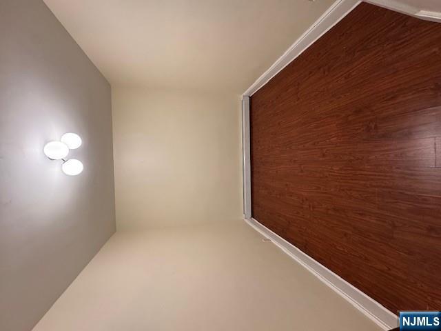 295 Midland Avenue, Unit 1 Garfield, NJ 07026 - Photo 7 of 8 an empty room with wooden floor and windows