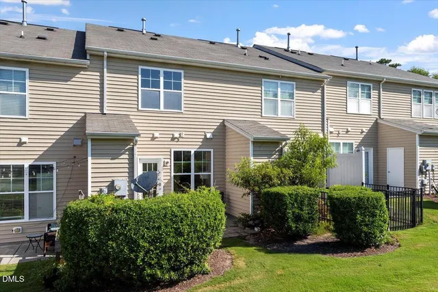 a view of a house with a yard and plants