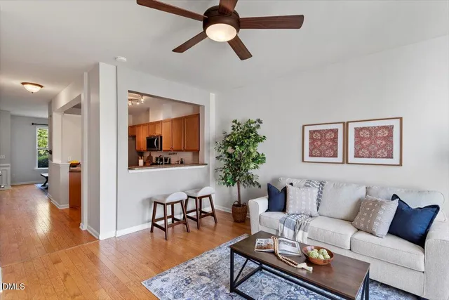 a living room with furniture and a wooden floor
