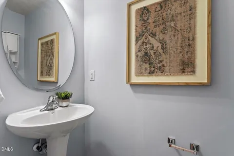 a bathroom with a sink a mirror and a toilet