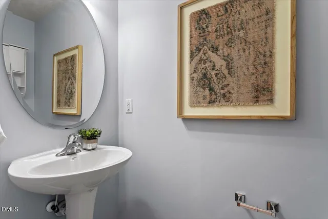 a bathroom with a sink a mirror and a toilet