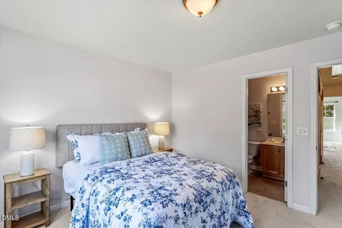 a bedroom with a bed and a lamp