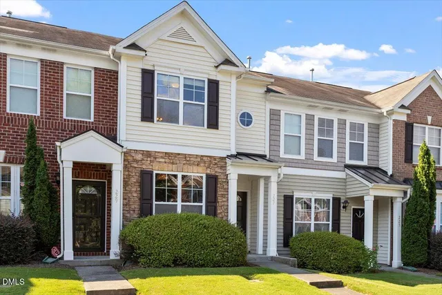 a view of a yard in front of a brick house