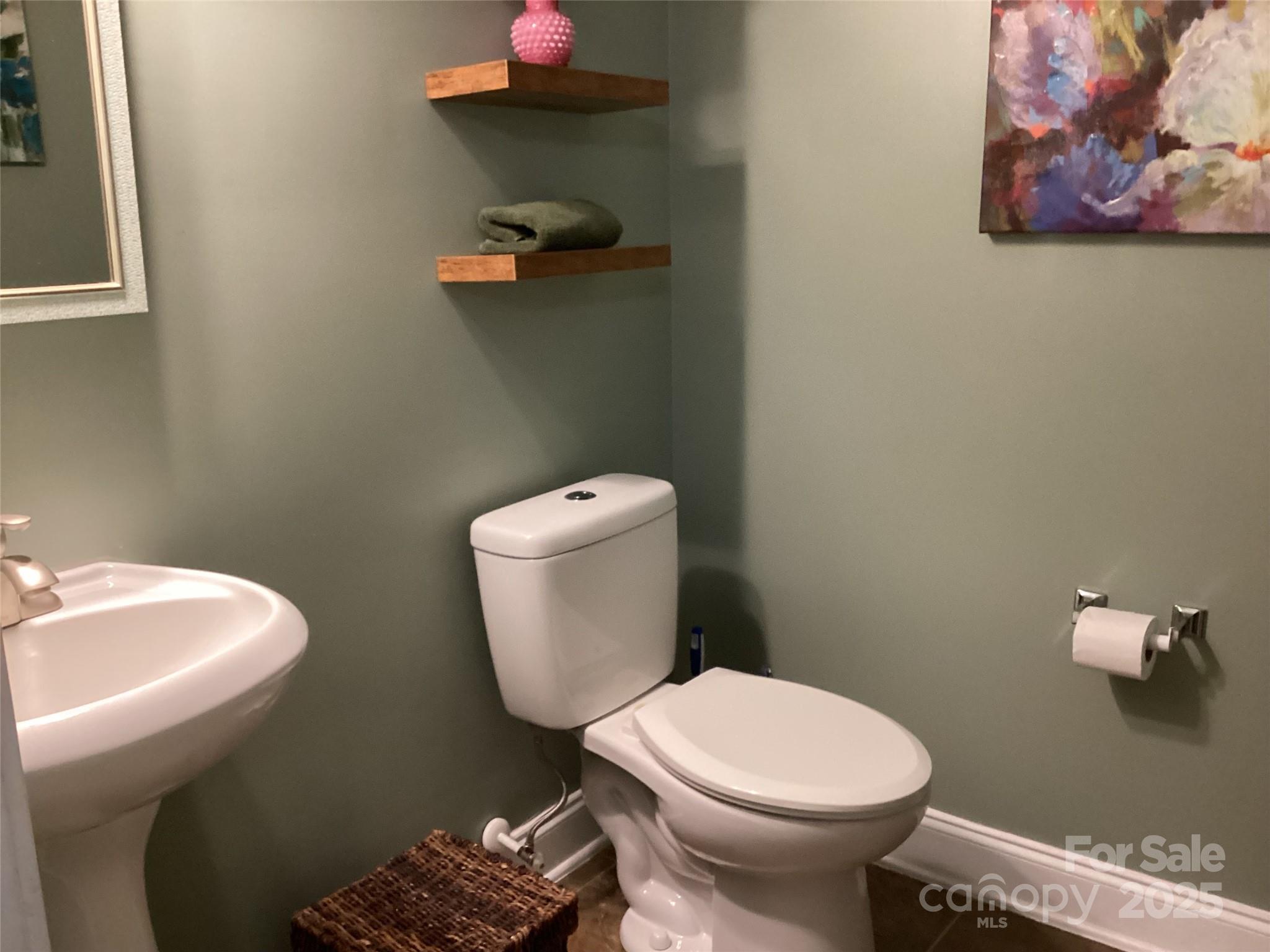 408 Indigo Ridge Drive Columbia, SC 29229 - Photo 7 of 17 a white toilet sitting next to a bathroom sink