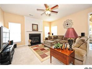 118 Hollyhurst Lane Fort Mill, SC 29708 - Photo 2 of 16 a living room with furniture a fireplace and a flat screen tv