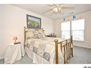 118 Hollyhurst Lane Fort Mill, SC 29708 - Photo 12 of 16 a bedroom with a bed and a chandelier
