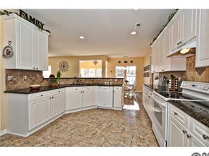 118 Hollyhurst Lane Fort Mill, SC 29708 - Photo 6 of 16 a kitchen with granite countertop a stove top oven a sink a counter space and cabinets