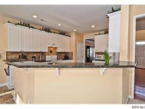118 Hollyhurst Lane Fort Mill, SC 29708 - Photo 7 of 16 a kitchen with stainless steel appliances granite countertop a sink a stove and a refrigerator