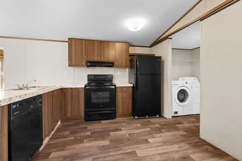 a kitchen with a refrigerator and a sink