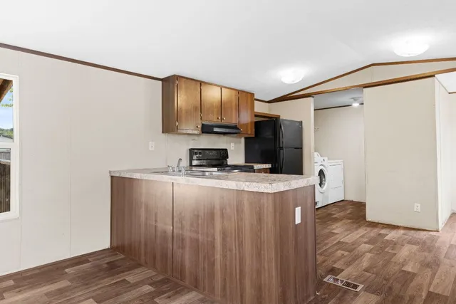 a kitchen with stainless steel appliances a refrigerator and a stove top oven