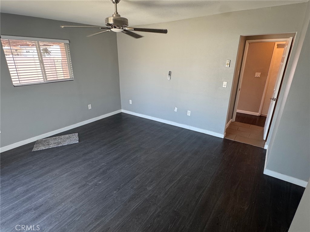 926 Griffith Way Hemet, CA 92543 - Photo 18 of 30 an empty room with wooden floor and windows