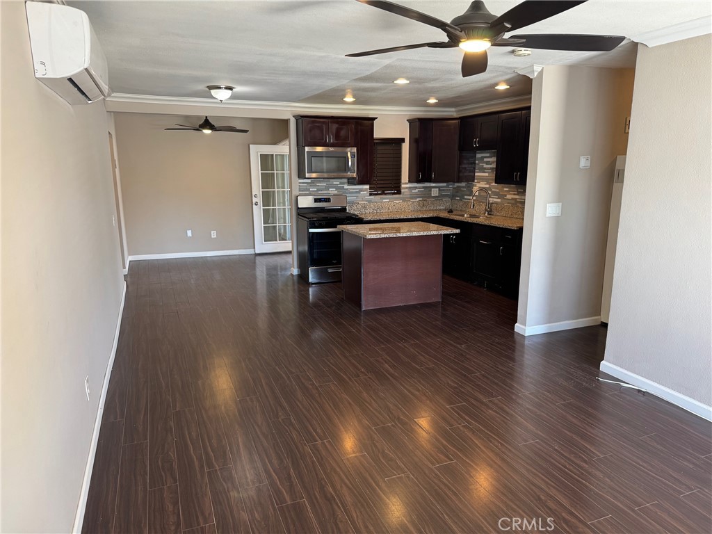 926 Griffith Way Hemet, CA 92543 - Photo 2 of 30 a kitchen with stainless steel appliances kitchen island granite countertop wooden floors and a sink