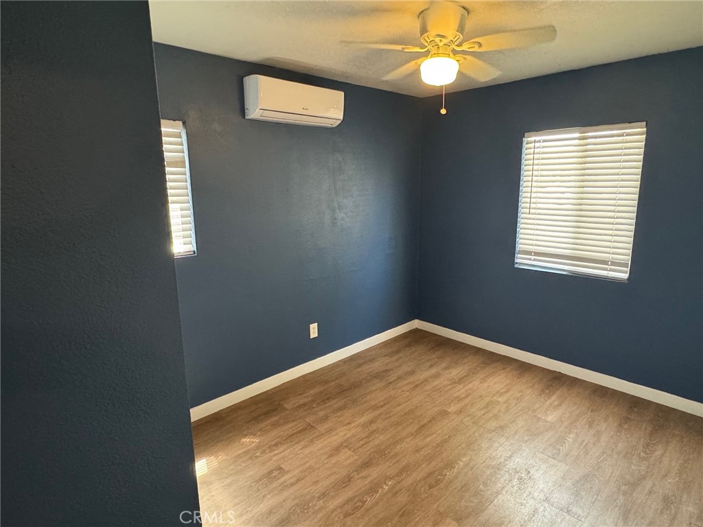 926 Griffith Way Hemet, CA 92543 - Photo 9 of 30 an empty room with windows and fan