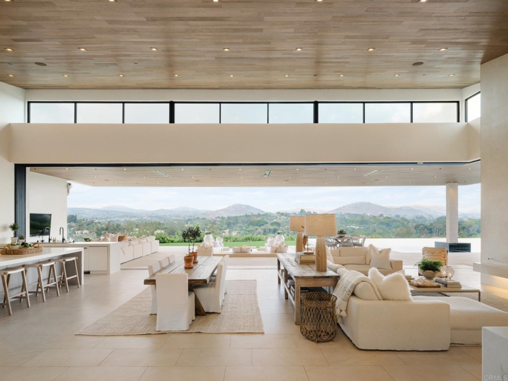 5516 La Crescenta Road Rancho Santa Fe, CA 92067 - Photo 22 of 68 a living room with furniture and a floor to ceiling window