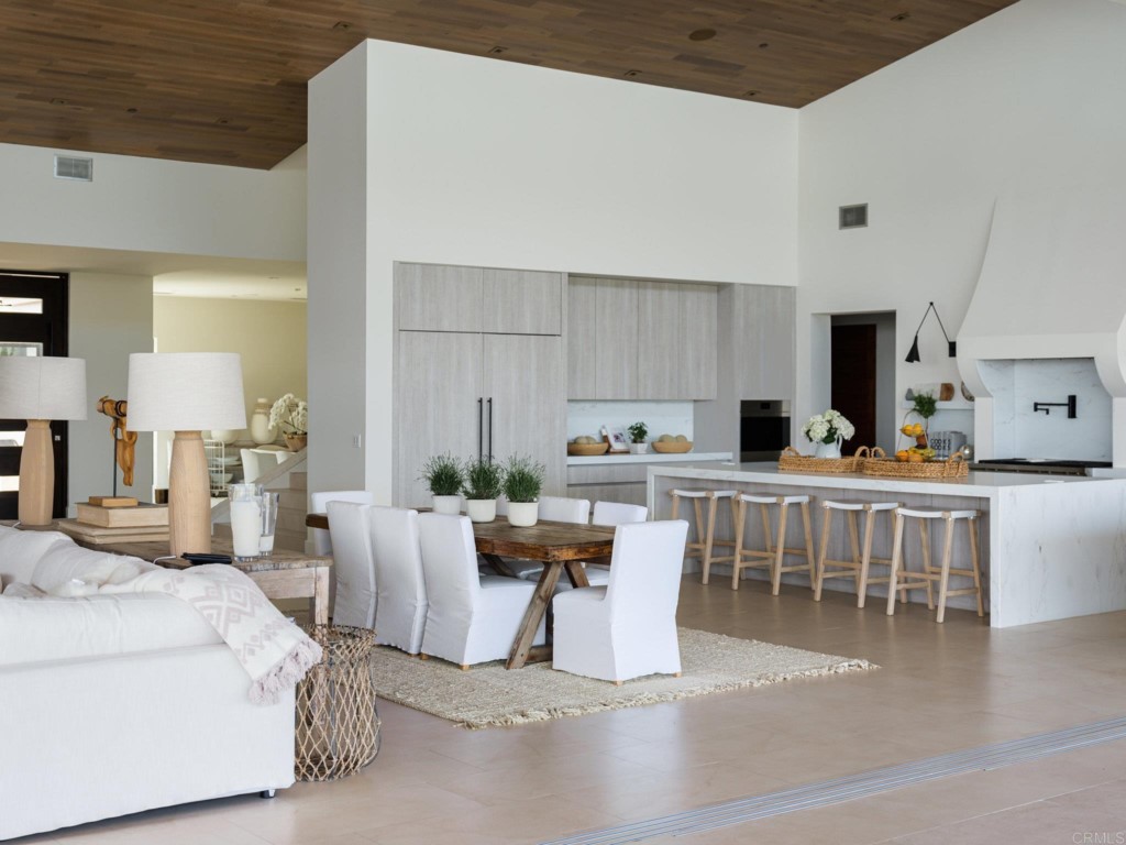 5516 La Crescenta Road Rancho Santa Fe, CA 92067 - Photo 26 of 68 a living room with furniture a wooden floor and a view of kitchen