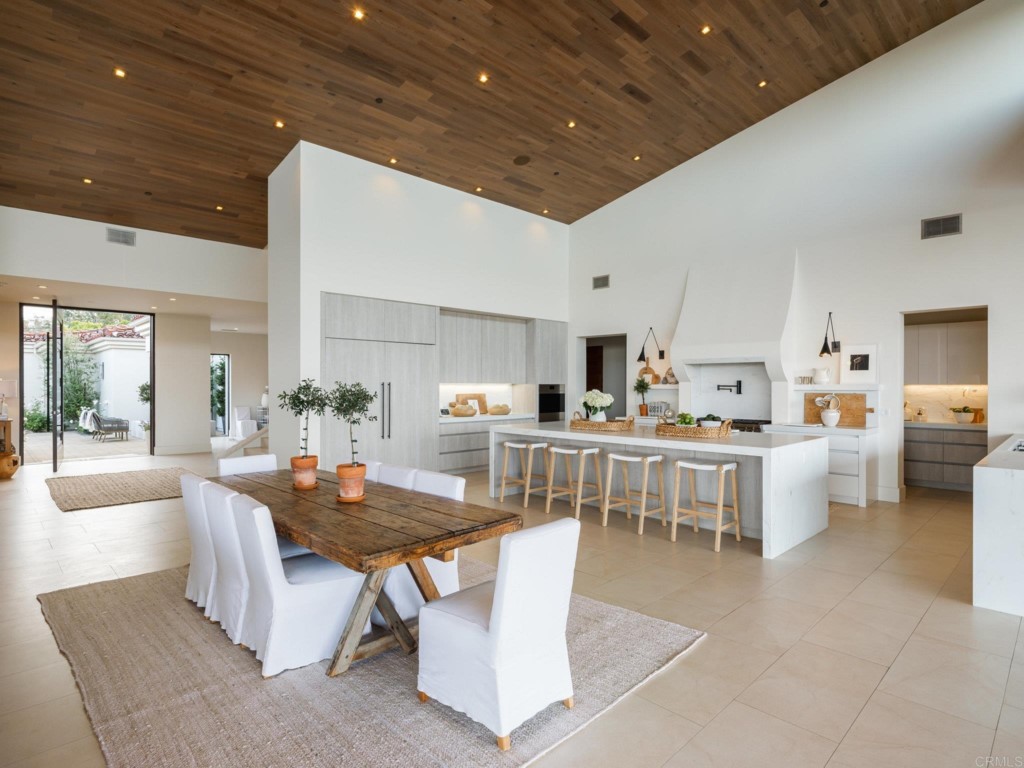 5516 La Crescenta Road Rancho Santa Fe, CA 92067 - Photo 27 of 68 a dining room with kitchen island furniture a large window and kitchen view