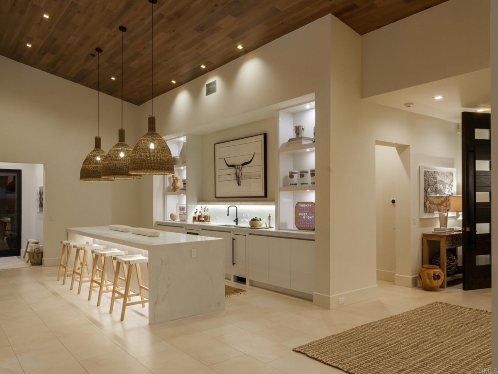 5516 La Crescenta Road Rancho Santa Fe, CA 92067 - Photo 29 of 68 a kitchen with stainless steel appliances kitchen island granite countertop a sink and cabinets