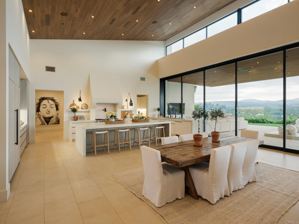 5516 La Crescenta Road Rancho Santa Fe, CA 92067 - Photo 32 of 68 a living room with couches a coffee table and kitchen view with wooden floor