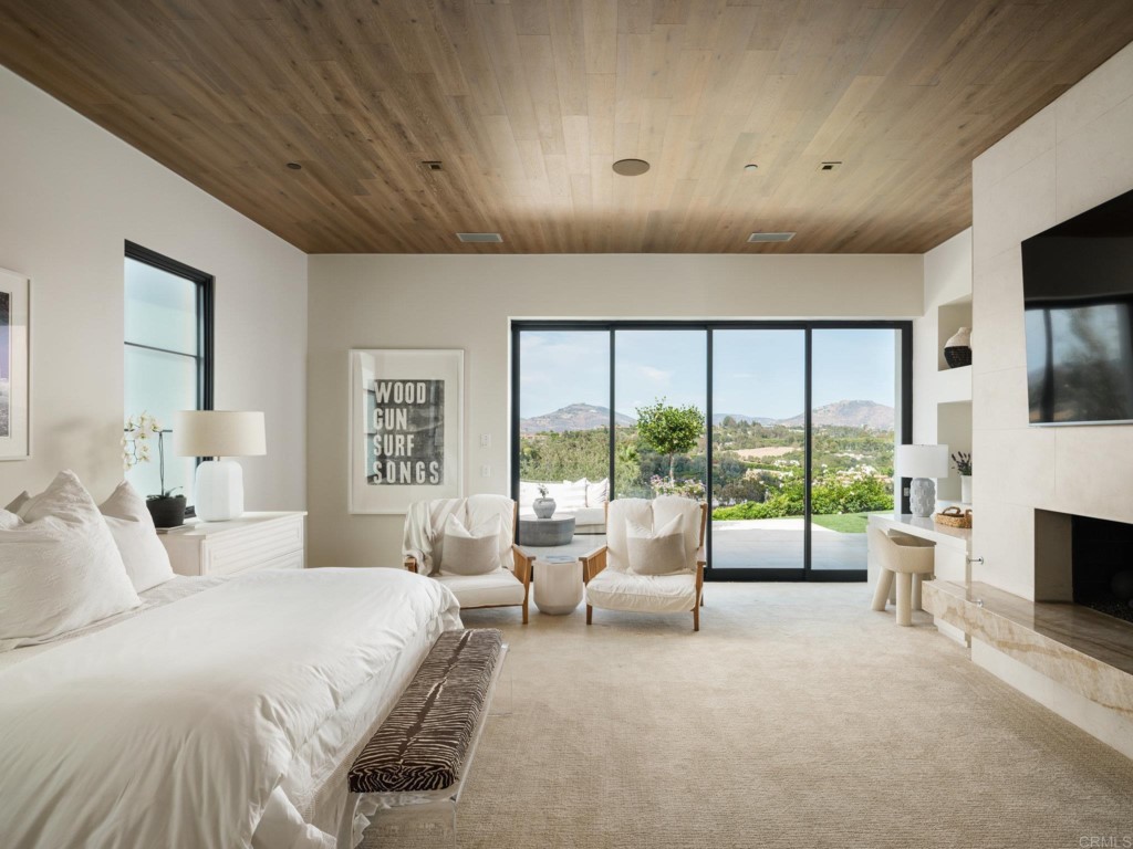 5516 La Crescenta Road Rancho Santa Fe, CA 92067 - Photo 37 of 68 a spacious bedroom with a large bed and a large window