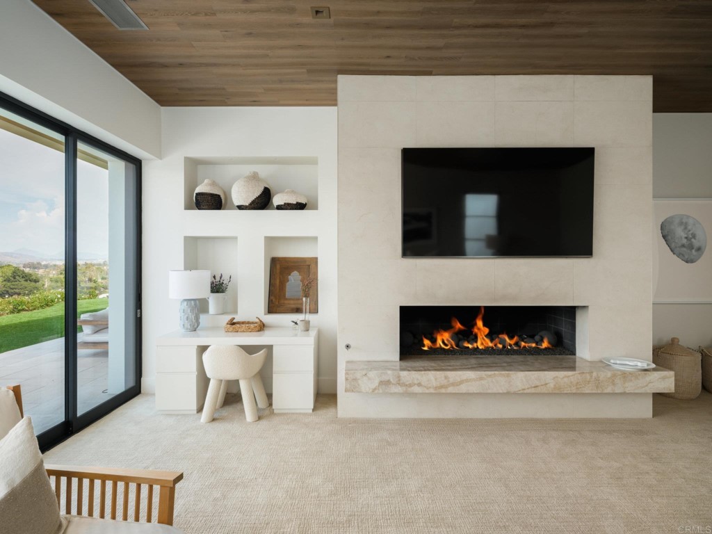 5516 La Crescenta Road Rancho Santa Fe, CA 92067 - Photo 39 of 68 a living room with furniture a fireplace and a floor to ceiling window
