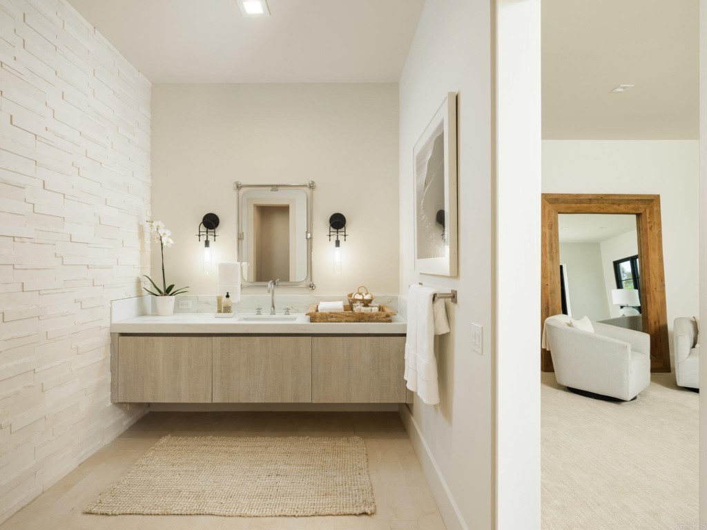 5516 La Crescenta Road Rancho Santa Fe, CA 92067 - Photo 46 of 68 a en suite bathroom with a sink double vanity and mirror
