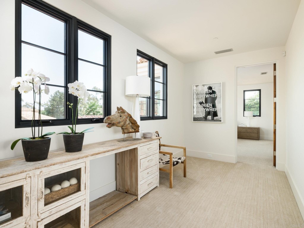 5516 La Crescenta Road Rancho Santa Fe, CA 92067 - Photo 52 of 68 a kitchen with stainless steel appliances a stove and white cabinets next to a window