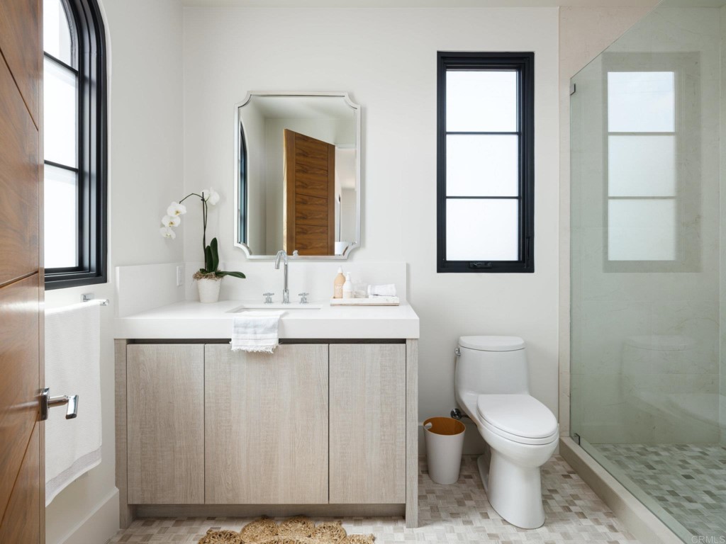 5516 La Crescenta Road Rancho Santa Fe, CA 92067 - Photo 54 of 68 a bathroom with a toilet sink and mirror