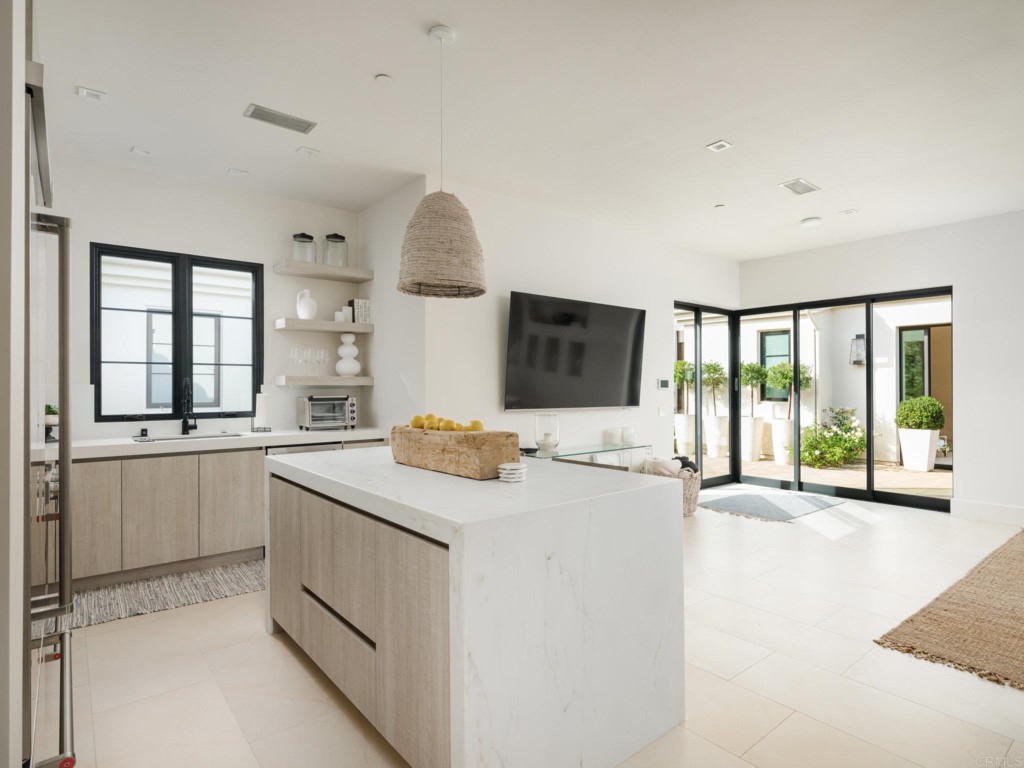 5516 La Crescenta Road Rancho Santa Fe, CA 92067 - Photo 60 of 68 a view of a kitchen with granite countertop a sink and a stove top oven