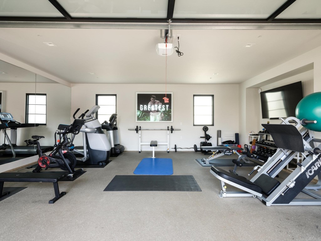 5516 La Crescenta Road Rancho Santa Fe, CA 92067 - Photo 62 of 68 a room with gym equipment and a view of living room
