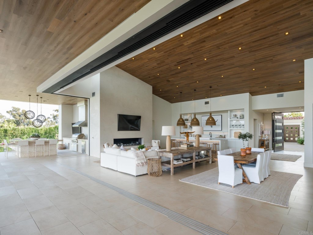 5516 La Crescenta Road Rancho Santa Fe, CA 92067 - Photo 8 of 68 a living room with furniture and a flat screen tv