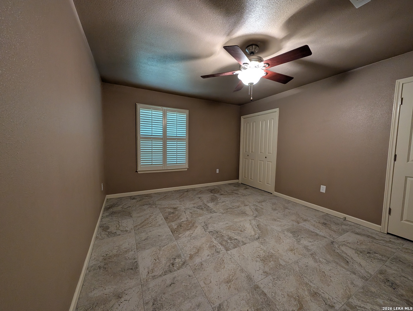 551 Terminal Loop Road, Unit D5 McQueeney, TX 78123 - Photo 18 of 42 an empty room with chandelier fan and windows