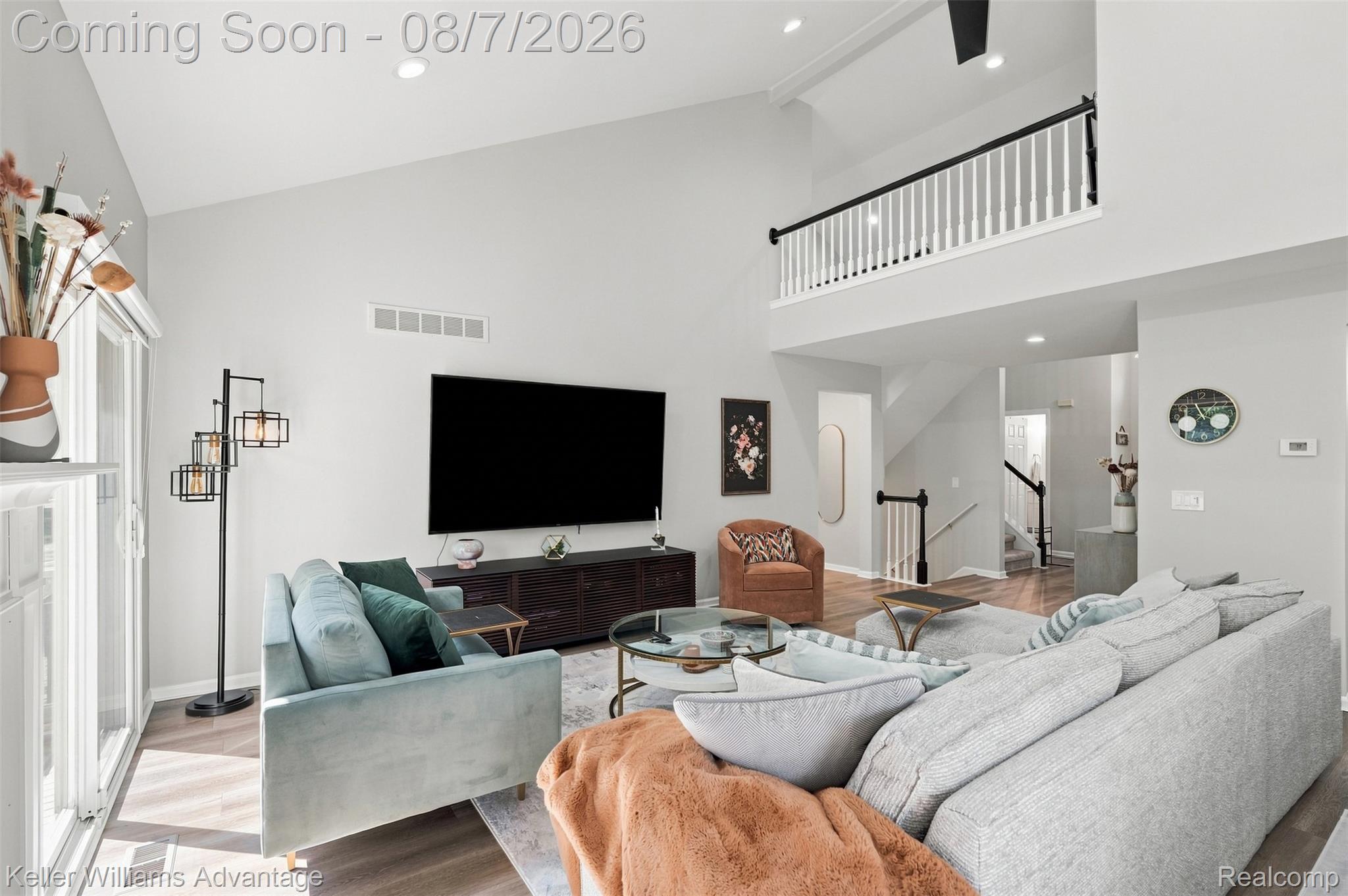 5325 Simpson Lake Road West Bloomfield, MI 48323 - Photo 5 of 43 Vaulted ceiling with recessed lighting, wood-finish flooring, white spindle railing, black handrail, and built-in media console