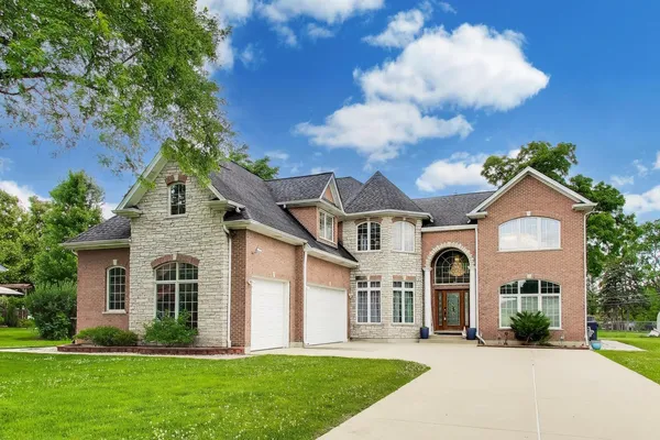 a front view of a house with a yard and garage