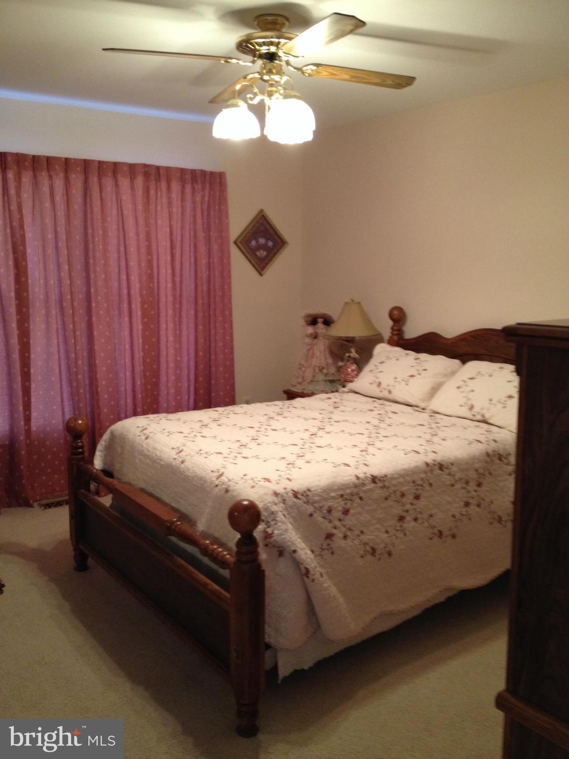 7244 Wilson Road Marshall, VA 20115 - Photo 11 of 30 a bedroom with a bed and a chandelier