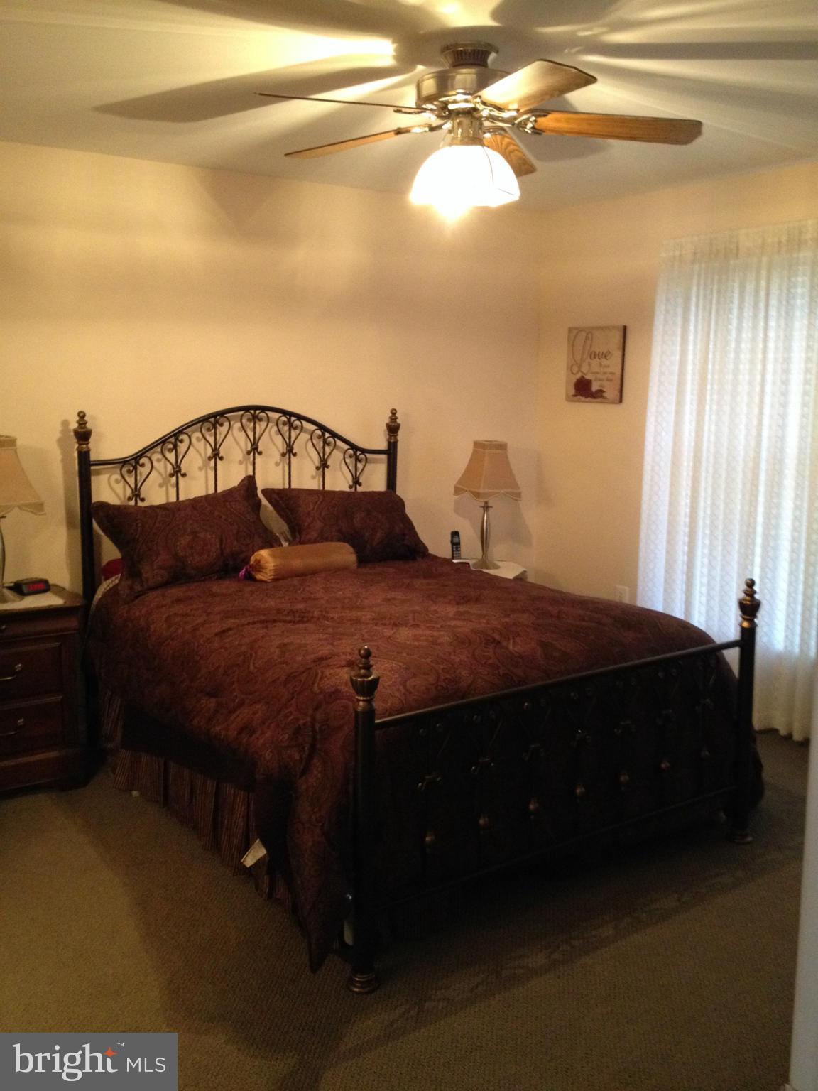 7244 Wilson Road Marshall, VA 20115 - Photo 13 of 30 a large bed sitting in a bedroom next to a window