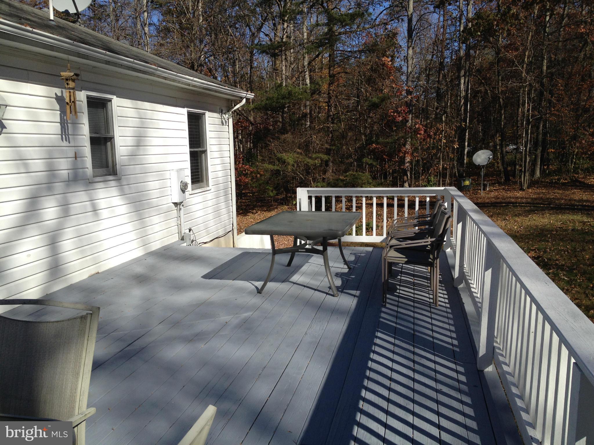 7244 Wilson Road Marshall, VA 20115 - Photo 23 of 30 a view of a roof deck with wooden floor and fence