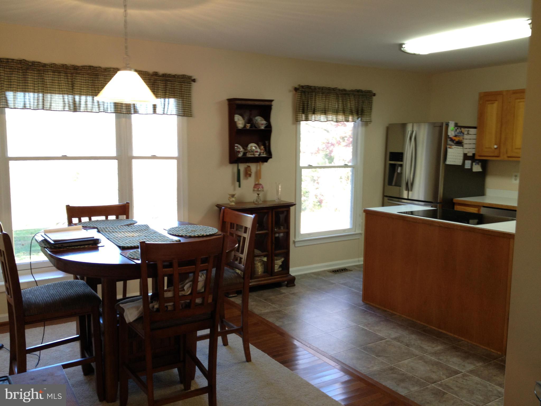 7244 Wilson Road Marshall, VA 20115 - Photo 5 of 30 a dining room with furniture a window and wooden floor