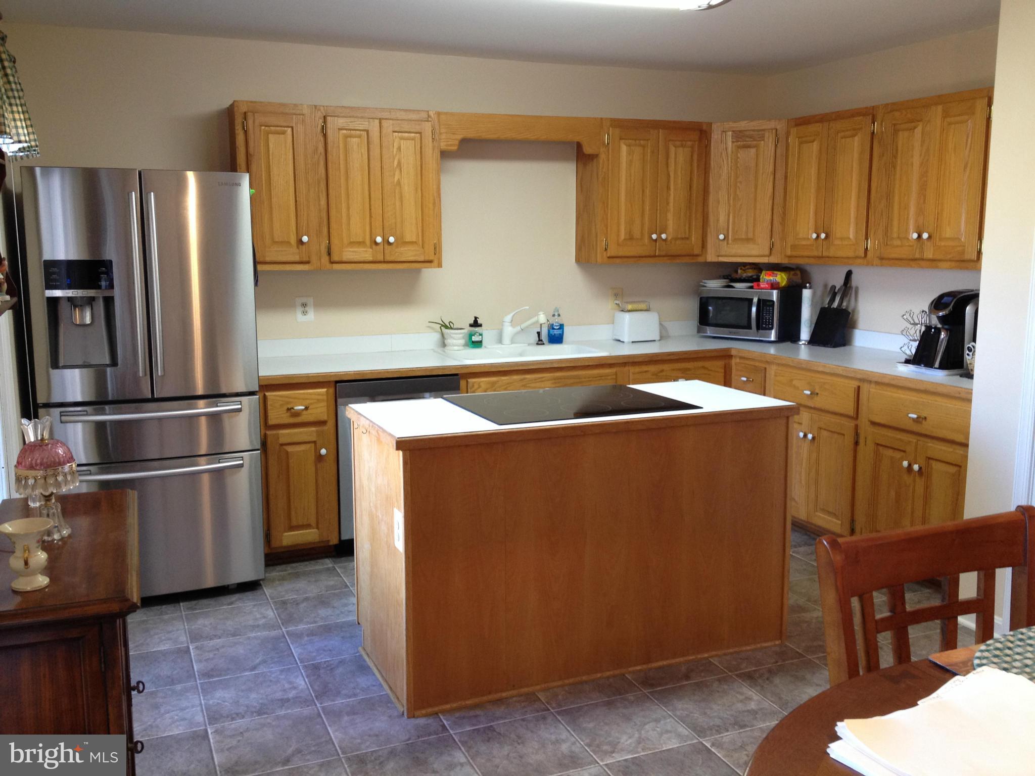 7244 Wilson Road Marshall, VA 20115 - Photo 7 of 30 a kitchen with stainless steel appliances granite countertop a refrigerator a sink a stove and island