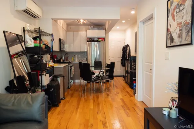 a view of a living room with furniture and wooden floor